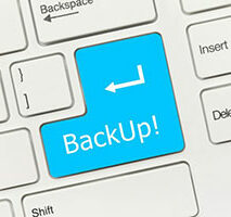 A keyboard with a blue "backup!" command key highlighting the importance of data backup.