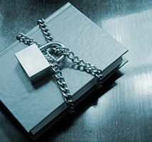 A book secured with a chain and a padlock.